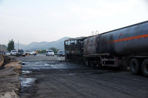 Photo taken on August 26, 2012 shows the accident site after a collision between a 39-seat bus and a methanol-loaded tanker occurred in Yan'an city, Northwest China's Shaanxi Province, August 26, 2012. The two vehicles caught fire after the collision in early Sunday morning, and at least 36 people were killed in the accident. Three people survived, but suffered injuries, said the local police. Photo: Xinhua