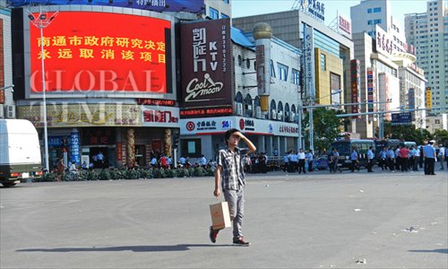 Pictured is a red Billboard at a crossing of Renmin Road and Jianghai Road in Qidong of Nantong, Jiangsu Province, saying that 