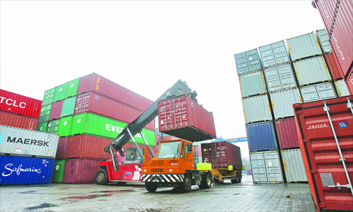 Containers are being unloaded in a port in Nantong, East China's Jiangsu Province Wednesday.Photo: CFP