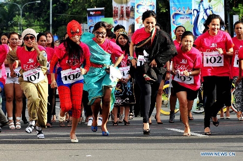  Indonesian women wearing high-heel shoes compete during Fun With Your Heels race in Jakarta, Indonesia, April 14, 2013. Runners were required to wear 7cm-high-heel shoes during the race. (Xinhua/Agung Kuncahya B.)