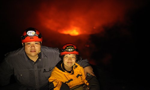 Zhang Xinyu (left) and his fiancée Liang Hong pose atop of volcano Mount Yasur on Tanna Island, Vanuatu, in November 2012. Photo: Courtesy of Zhang  Xinyu