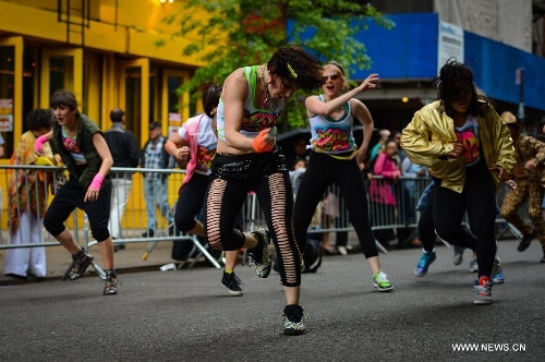 People participate in the annual Dance Parade in New York, on May 18, 2013. Over 200 dance groups showcasing 80 unique dance styles and cultures gathered from Broadway to the East Village on Saturday for the 7th Dance Parade in New York. (Xinhua/Niu Xiaolei) 