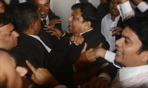Bangladeshi lawyers representing the Awami League and Bangladesh Nationalist Party tussle following the dismissal of Abdul Quader Molla's appeal against his execution in Dhaka on Thursday. Photo: AFP