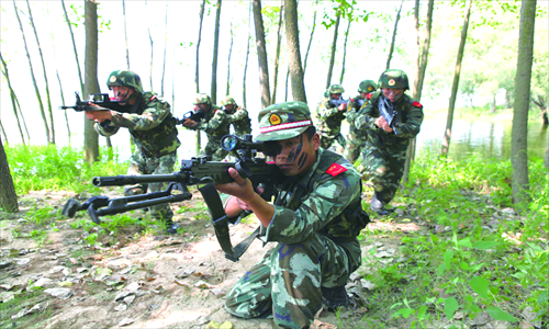 Seven armed police officers participate in an anti-terrorism drill in Bozhou, Central China's Anhui Province on Sunday. The armed police unit reinforced its abilities to fight terrorism and maintain stability, ahead of the 85th anniversary of the founding of People's Liberation Army, which falls on August 1. Photo : CFP 