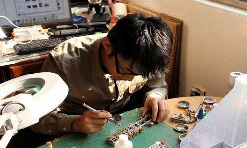 Wu Bayin works on a model. Photo: Courtesy of Wu Bayin 