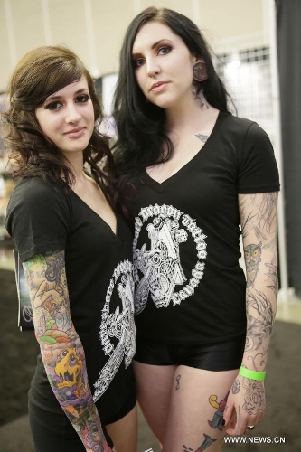 Tattoo lovers display their tattoos during the 5th Vancouver tattoo and culture show in Vancouver, Canada, on April 26, 2013. The 5th Vancouver tattoo and culture show presents different tattoo art works from nearly 200 tattoo artists from across the world attracting thousands of tattoo lovers here on Friday. (Xinhua/Liang Sen) 