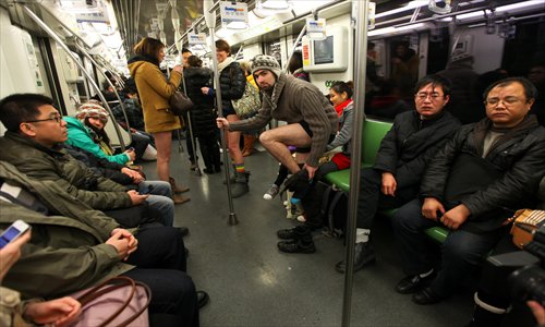 A foreigner takes off his trousers on a metro Line 2 train Sunday. The annual 
