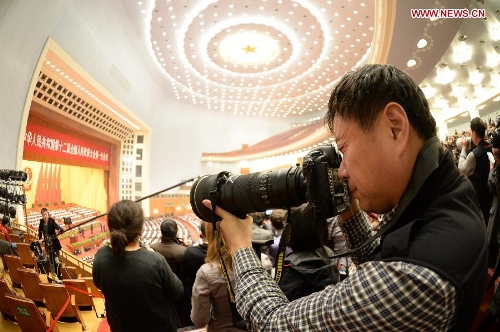  A journalist works at the closing meeting of the first session of the 12th National People's Congress (NPC) at the Great Hall of the People in Beijing, capital of China, March 17, 2013. (Xinhua/Chen Shugen)