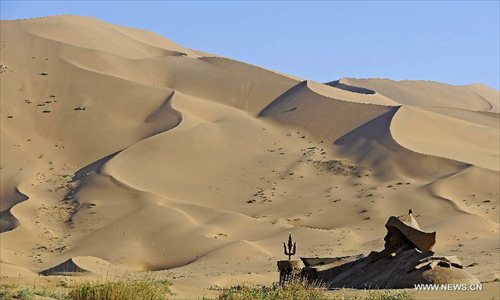 Photo taken on June 19, 2012 shows scenery of the Badain Jaran Desert in Alashan of north China's Inner Mongolia Autonomous Region. The Badian Jaran Desert is 47,000 square km and sparsely populated. It is famous for having the tallest stationary sand dunes in the world. Some dunes reach a height of 500 meters. But it also features spring-fed lakes that lie between the dunes. Photo: Xinhua