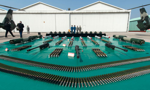 Dempsey tours aircraft weaponry with Chinese army aviation staff at an airbase on April 24.