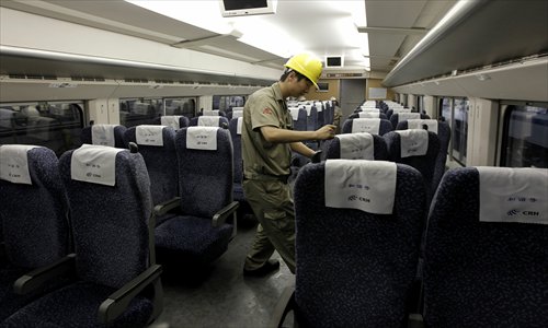 A worker checks the seats inside a bullet train. Photo: Yang Hui/GT