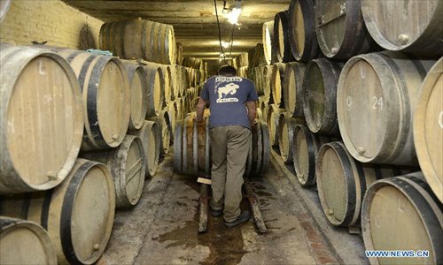 A staff moves a wooden barrel used to store lambic beers at the Cantillon breweryin Brussels, capital of Belgium on Nov. 10, 2012. Cantillon brewery, founded in 1900, is one of the few beer brewers still running in Brussels city. It follows traditional way to brew lambic style beers, a unique spontaneous fermented beer only produced in Brussels region. Photo: Xinhua