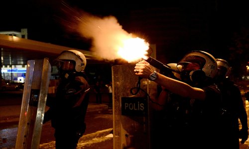 Turkish riot police fire tear gas canisters during clashes with anti-government demonstrators in Ankara, Turkey, early on June 18. Clashes over the clearing of Gezi Park in Istanbul on June 15, in which over 350 people were arrested, have continued in Istanbul and the country's capital. Photo: CFP