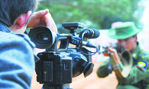  Chen Fu's brother Chen Gui  takes film footage in Kokang. Photo: Courtesy of Chen Fu