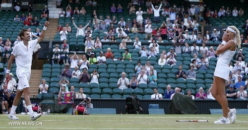 Daniel Nestor of Canada and Kristina Mladenovic (R) of France celebrate after the final of mixed doubles against Bruno Soares of Brazil and Lisa Raymond of the United States on day 13 of the Wimbledon Lawn Tennis Championships at the All England Lawn Tennis and Croquet Club in London, Britain, on July 7, 2013. Daniel Nestor and Kristina Mladenovic claimed the title with 2-1. (Xinhua/Wang Lili) 
