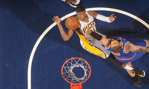 Paul George (left) of the Indiana Pacers shoots against Tyson Chandler of the New York Knicks on Tuesday. Photo: CFP