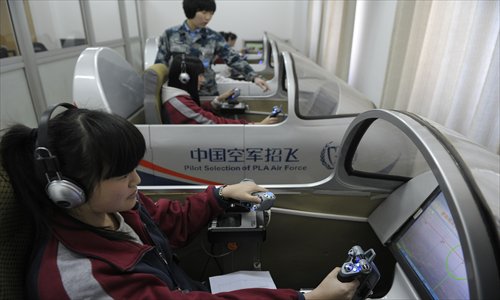 High-school student candidates for the PLA Air Force experience flying in a simulator. Photo: CFP