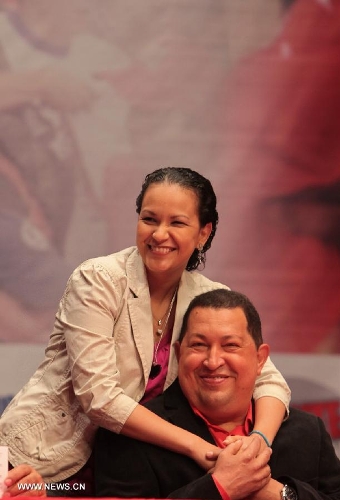 File photo taken on Feb. 23, 2012 shows Venezuelan President Hugo Chavez and his daughter Rosa posing during a party in Caracas, Venezuela. Venezuelan government confirmed President Hugo Chavez's death on March 5, 2013. (Xinhua) 