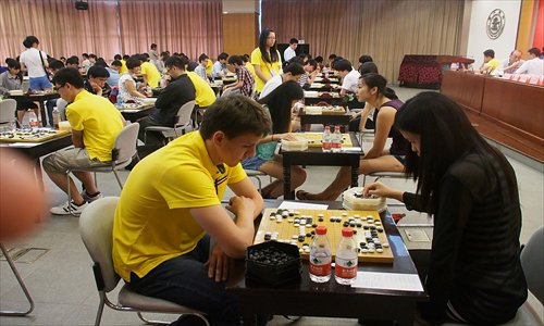 Two competitors play a match of Go Tuesday at the International University WEICHI Invitation Tournament 2013 at Shanghai Jiao Tong University. The 4-day event attracted 98 players from 57 universities around the world. World champion Chang Hao will make an appearance Friday afternoon to speak with participants. Photo: CFP