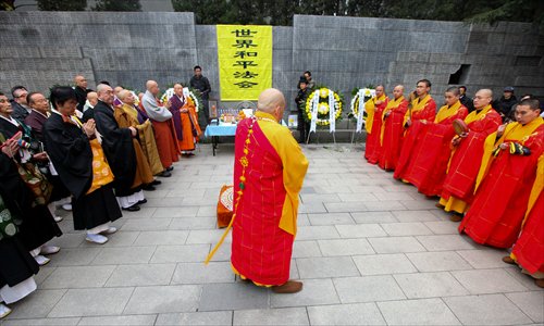 Earlier in the Thursday morning, 200 monks from Buddhist temples in Nanjing and Japan braved the cold and started a praying ceremony, chanting mantras in front of a 