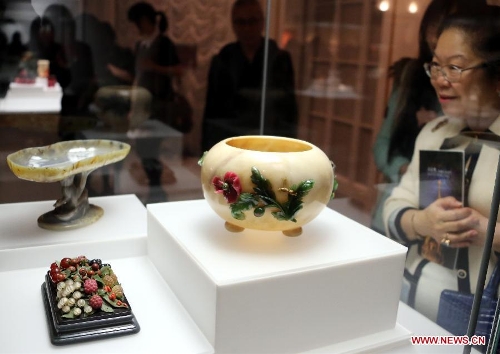 A visitor looks at craftworks presented on the exhibition of 