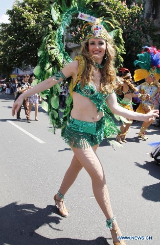 A dancer in a florid costume performs at the grand parade of the 2013 Berlin Carnival of Cultures Festival, in Kreuzberg District of Berlin, Germany, May 19, 2013. More than 4,000 revelers representing the ethnic communities from some 80 countries and regions in Berlin took part in the annual parade on Sunday, showcasing the cultural diversity and affluence of the German capital. (Xinhua/Pan Xu) 