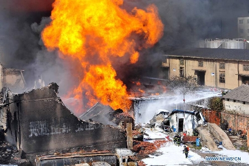 Firefighters work at the accident site after an explosion ripped through a warehouse of a chemical factory in the Dongxihu District of Wuhan, capital city of central China's Hubei Province, April 13, 2013. The casualties were unknown so far. (Xinhua/Xiao Yijiu)