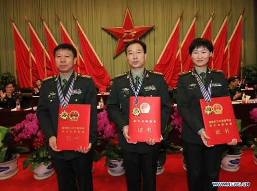 Chinese astronauts Liu Wang, Jing Haipeng and Liu Yang (from L to R) attend an awarding ceremony to honor the Shenzhou-9 flight crew in Beijing, capital of China, October 29, 2012. Three astronauts of the Shenzhou-9 mission who conducted China's first manned space docking in June have received awards for their service to the country's space endeavors. Jing Haipeng, commander of the Shenzhou-9 flight crew, was honored with a second-class aerospace achievement medal; Liu Wang and Liu Yang, who is China's first female astronaut, were both conferred third-class medals. Photo: Xinhua