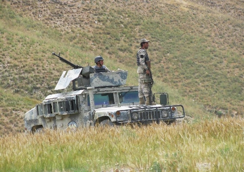 Afghan policemen keep watch on a military vehicle on the border between Afghanistan and Pakistan in Goshta district of nangarhar province in eastern of Afghanistan on May 7, 2013. Afghanistan summoned on Monday the Pakistani Charge d'Affaires and lodged protest over 