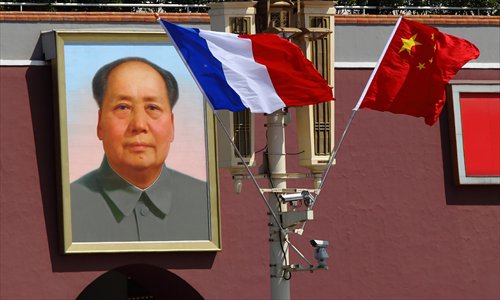 Both Chinese and French national flags rise at Tiananmen Square Thursday to welcome French President Francois Hollande who was starting his first two-day visit to China. Photo: CFP