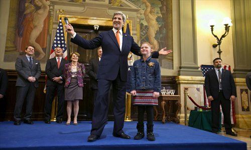 US Secretary of State John Kerry (center) jokes beside Virginia Walker, 9, during a visit with US embassy staff and their families in Rome on February 28. Rome was the fourth leg of Kerry's first official overseas trip through Europe and the Middle East. Photo: AFP 