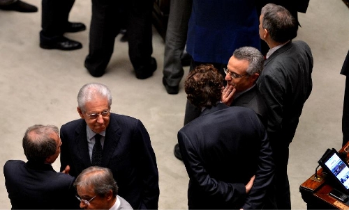 &nbsp;Italian Prime Minister Mario Monti (L) talks with other deputies in Rome, Italy, on April 20, 2013. Italian President Giorgio Napolitano on Saturday won election for a second mandate in a move to solve Italy's political impasse. (Xinhua/Xu Nizhi) 