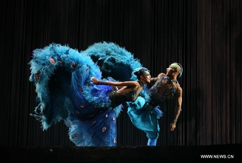 Chinese famous choreographer Yang Liping (L) performs in her final dance drama 