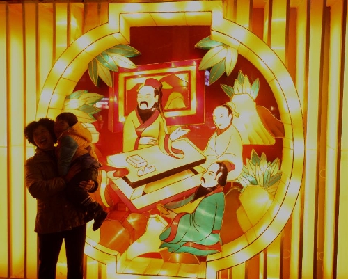 A woman poses for photo with a child in front of a fancy lantern during the 2013 Nanjing Qinhuai Lantern Show at the Confucius Temple in Nanjing, capital of east China's Jiangsu Province, Feb. 6, 2013. Around 500,000 lanterns are displayed during the event to celebrated the upcoming Spring Festival which falls on Feb. 10 this year. (Xinhua/Li Wenbao) 