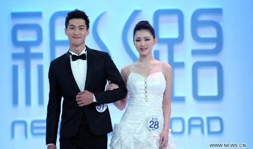Male group winner Chen Pang-an (L) takes part in the 2012 New Silk Road Taiwan Model Contest in Taipei, Southeast China's Taiwan, August 25, 2012. Forty-nine models competed for crowns in Saturday's contest. The winners will be qualified for the 2012 New Silk Road World Model Contest. Photo: Xinhua