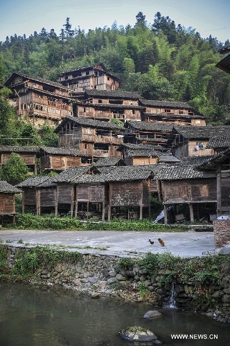 Photo taken on June 20, 2013 shows the folk houses in Dimen Dong minority village in Liping County of southwest China's Guizhou Province. Dimen is a Dong minority village with about 2,500 villagers. It is protected properly and all the villagers could enjoy their peaceful and quiet rural life as they did in the past over 700 years. (Xinhua/Ou Dongqu)