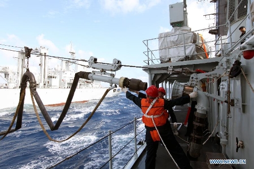 &nbsp;Crew members onboard missIle destroyer Harbin adjust the fuel pipe from the supply ship Weishanhu at South China Sea, Feb. 20, 2013. The supply ship Weishanhu reinforced the missile destroyer Harbin and the frigate Mianyang on Wednesday with fuel, fresh water and other materials. The 14th naval squad, sent by the Chinese People's Liberation Army (PLA) Navy, departed Saturday from China to the Gulf of Aden and Somali waters for escort missions. The fleet comprises three ships -- the missile destroyer Harbin, the frigate Mianyang and the supply ship Weishanhu -- carrying two helicopters and a 730-strong troop. (Xinhua/Rao Rao) 