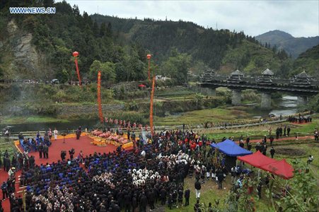 Photo taken on December 1, 2012 shows an overview of a celebration ceremony marking the 100th anniversary of the completion of Chengyang Fengshui Bridge held in Sanjiang Dong Autonomous county, South China's Guangxi Zhuang Autonomous Region. Built in 1912, the 77.76-meter-long bridge is famed for its combination of bridge, veranda and Chinese pavilion. (Xinhua/Wu Lianxun)