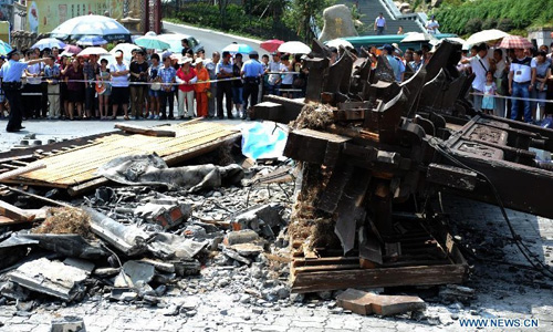 Photo taken on Aug. 12, 2012 shows the scene of a decorated archway toppling accident in Hefang Street, a busy commercial area and tourism destination in Hangzhou, capital of east China's Zhejiang Province. Two people were killed and several others injured after a decorated archway, or pailou, suddenly toppled down Sunday morning in Hangzhou. Photo: Xinhua