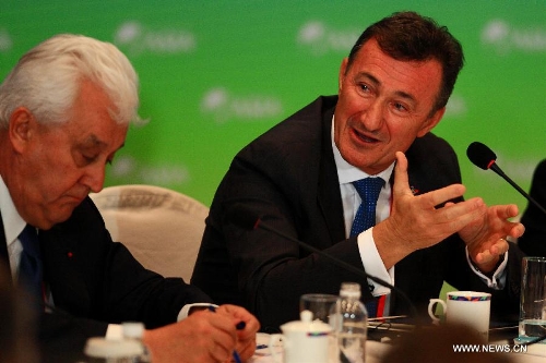 President and CEO of Dassault Systems Bernard Charles (R) speaks during a roundtable discussion themed in 