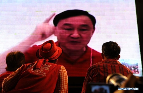 Thailand former prime minister Thaksin Shinawatra speaks to his supporters in screen via 