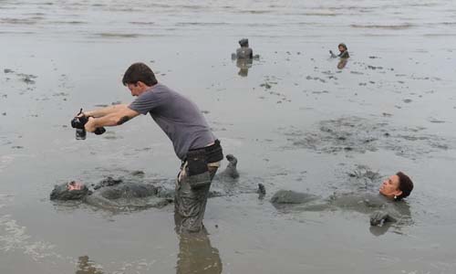 A photographer takes photos of a reveler who participates in the annual 