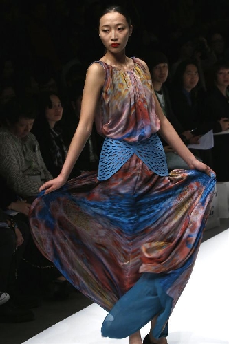 A model presents a creation designed by students from the Sino-French Institute of Fashion Designer in Shanghai University of Engineering Science during the first China Graduate Fashion Week in Beijing, capital of China, April 24, 2013. A total of 610 graduate students of fashion from 22 colleges will present their designs during the five-day event which kicked off on Wednesday. (Xinhua/Li Mingfang) 