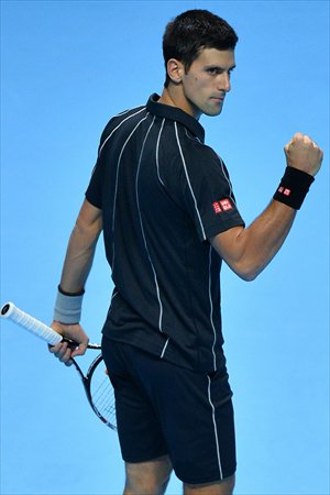 Novak Djokovic of Serbia celebrates winning the first set against Roger Federer of Switzerland at the ATP World Tour Finals in London on Tuesday. Photo: CFP