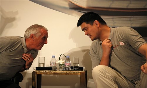 Yao Ming talks Wednesday with Simon Cooper, the president and managing director for Asia Pacific of Marriott International. The Yao Foundation received a 5 million yuan ($816,205) donation from Marriott to help add three hope schools to the 15 it has helped build. The money will also be used to support hope school basketball seasons. Photo: Cai Xianmin/GT