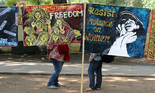 Demonstrators stand behind posters during a protest rally in New Delhi on Thursday. Demonstrators called for the resignation of P.J. Kurien, deputy chairman of the Upper House of Parliament, accused of being involved in a rape case. Demonstrators also demanded changes in a proposed law against sexual crimes, saying it needed to be stronger and more defined. Photo: AFP