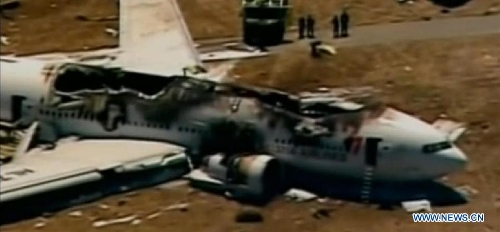 The video grab shows the wreckage of Asiana Airlines Boeing 777 airplane at San Francisco International Airport, California, the United States, on July 6, 2013. Two people were confirmed dead in Saturday's crash landing of an Asiana Airlines Boeing 777 passenger plane originated from Seoul, the Republic of Korea (ROK), at San Francisco International Airport, said San Francisco Fire Chief Joanne Hayes-White at a press conference. She also said 82 people injured were transported to local hospitals. (Xinhua)