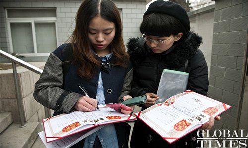 Elsie (left) signs her homemade marriage certificate.
