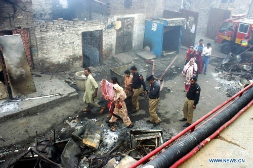 Pakistani Christians visit the burnt out houses after attacked by demonstrators during a protest in a Christian neighborhood in Badami Bagh area of eastern Pakistan's Lahore on March 9, 2013. Angry mob torched over 100 houses and shops of minority Christians in Badami Bagh area on Saturday after a Christian boy was accused of blasphemy, police and residents said. (Xinhua/Jamil Ahmed) 