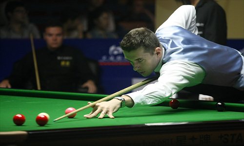Mark Selby, a professional snooker player from the UK, prepares a shot Tuesday at 2012 Shanghai Masters. Selby lost to Jamie Cope on the second day of the weeklong tournament. The world's top 32 snooker players will compete for a first prize of 3 million yuan ($474,600). Photo: CFP